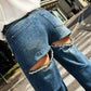 LM - Jeans Astor con strappi e strass posteriori 